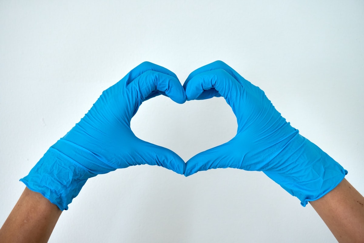 Cleaning professional making heart hands with blue rubber gloves in Oceanside CA